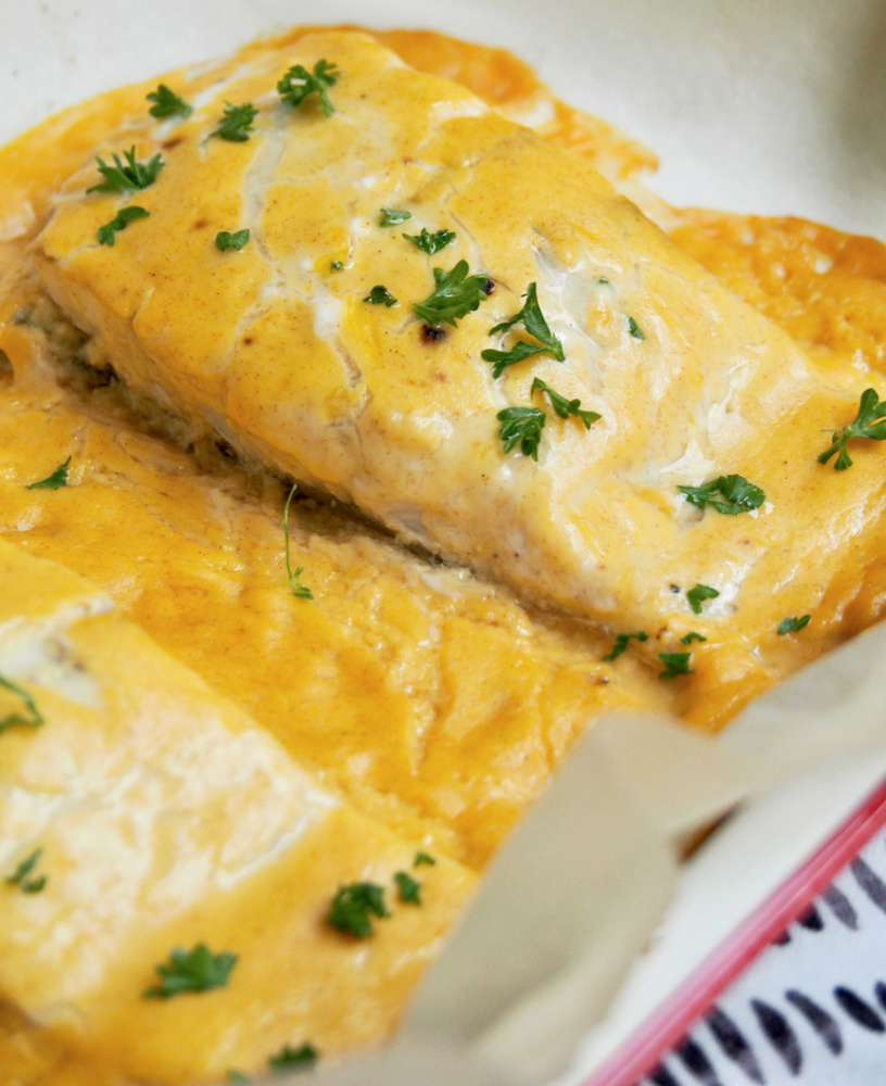 fish fillet baked in orange and mustard and garnished with chopped parsley