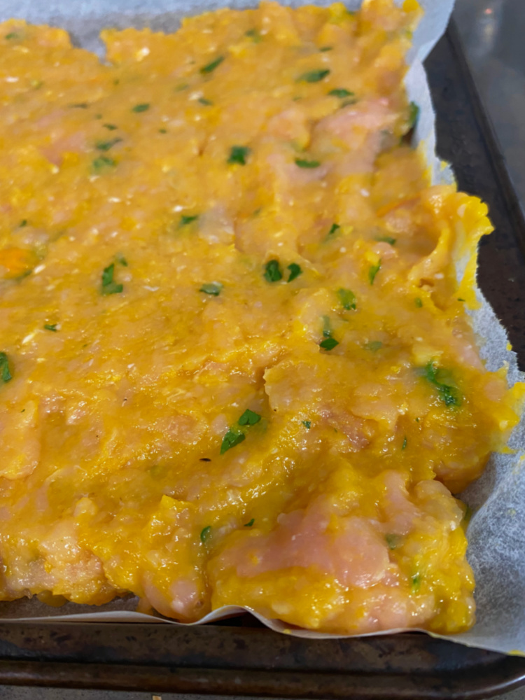 turkey mixture on lined baking tray ready to bake