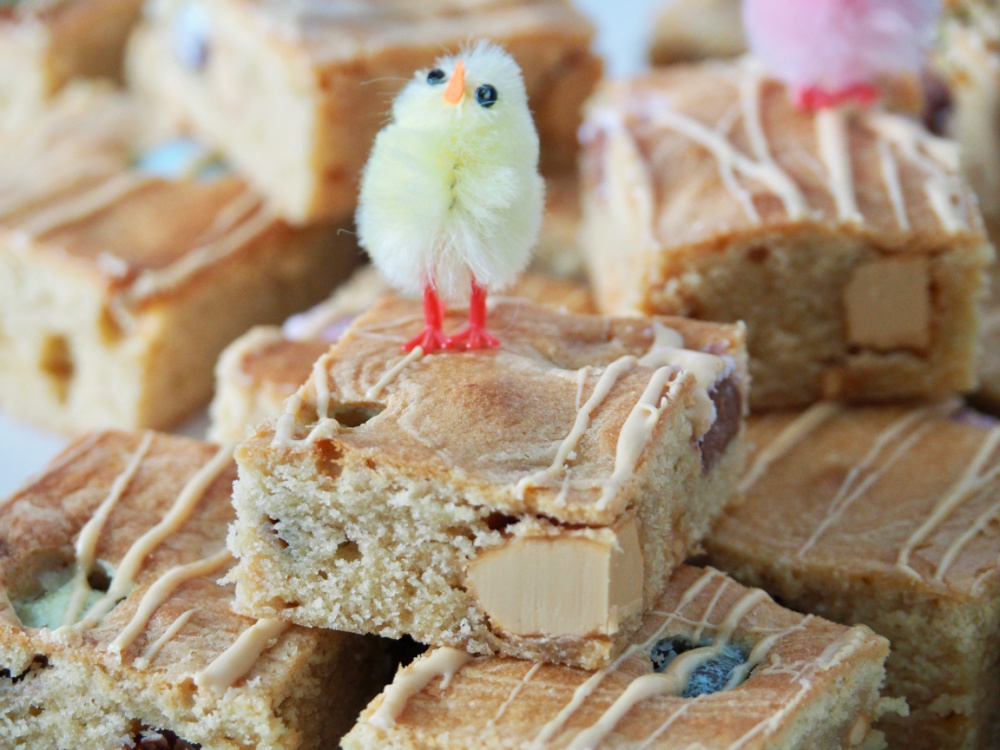 yellow fluffy decorative chick sitting on top of a caramilk blondie square