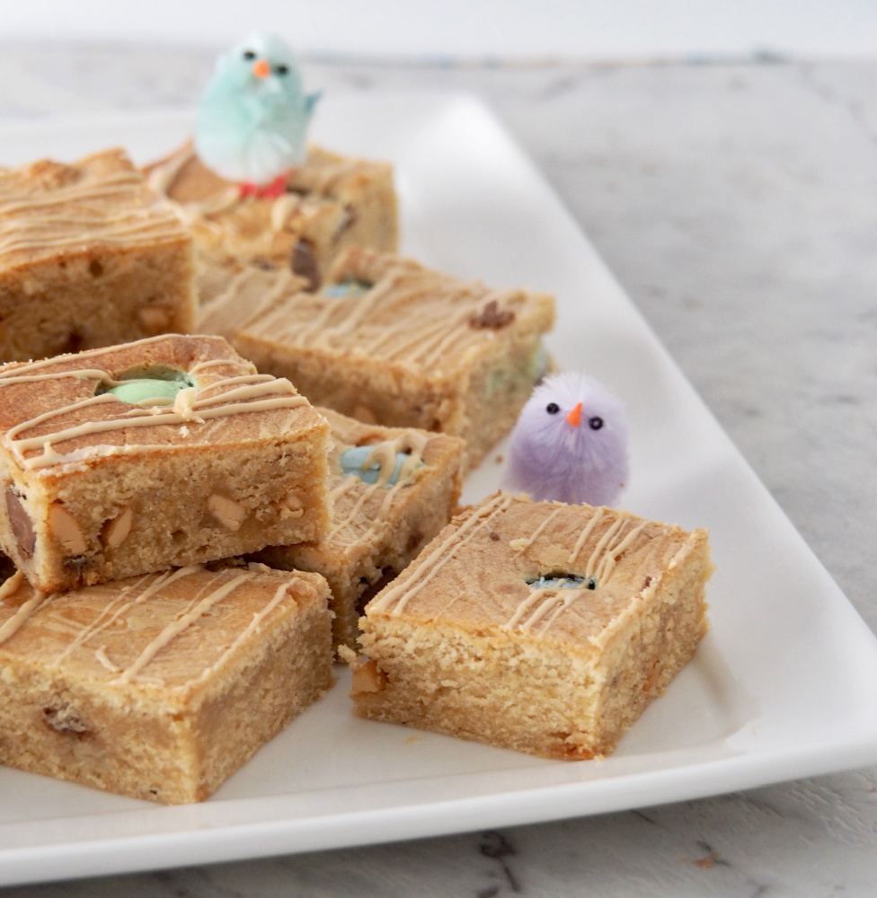 easter caramilk blondies on a plate with two decorative chicks on top