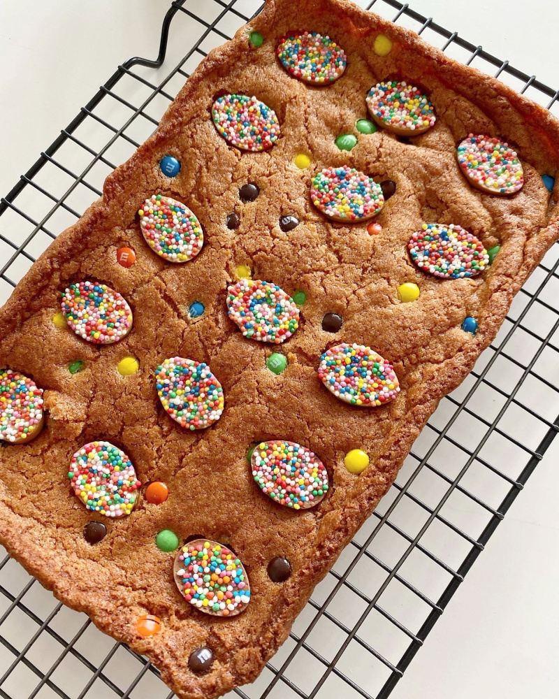 baked slice decorated with sprinkle easter eggs and mini m and ms 