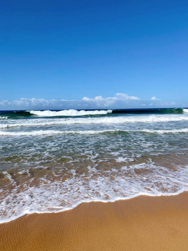 waves rolling onto golden sand