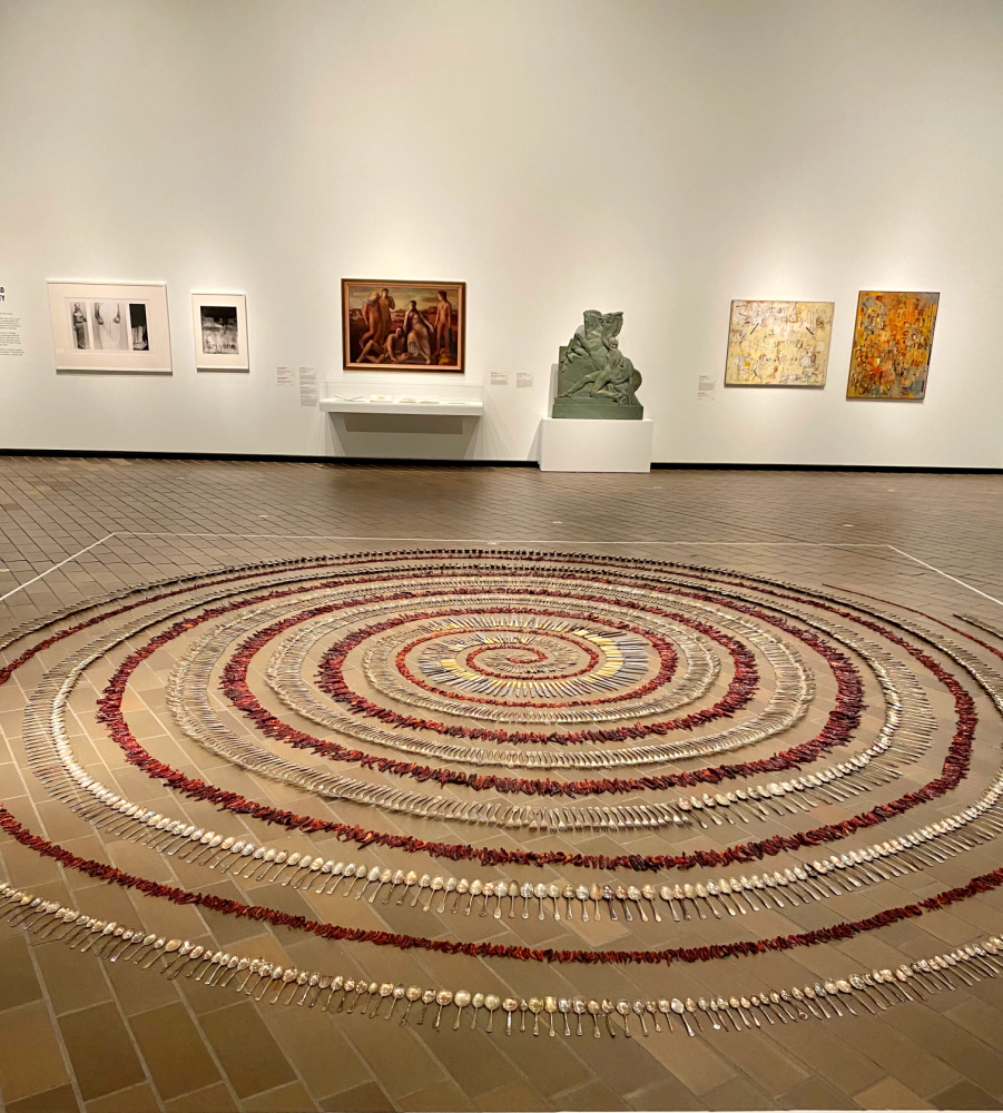 a huge spiral in a gallery made up of forks and dried red chillis