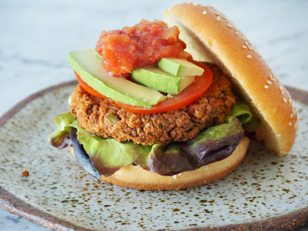 refried bean burger with bun lid removed