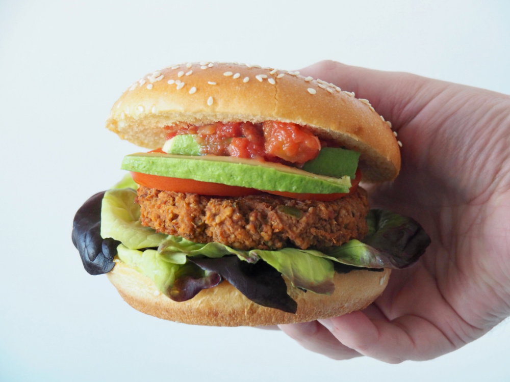 hand holding refried bean burger