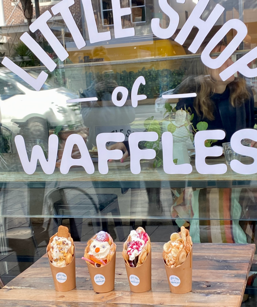 three waffle sundaes in a line outside a window that says Little Shop of Waffles