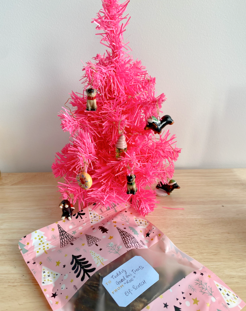a little pink christmas tree with mini dog decorations 