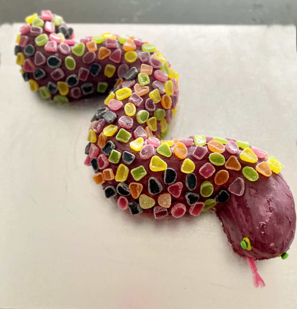 a purple snake covered in scales made of jubes cut in half