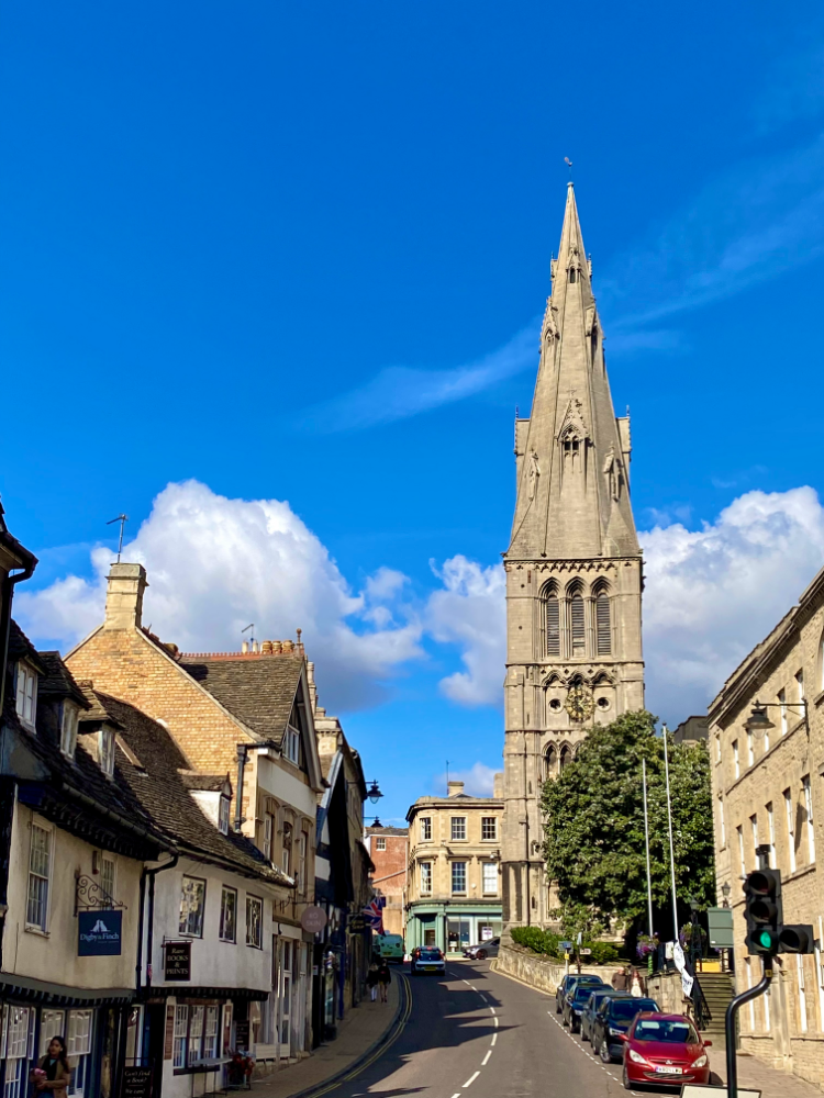 looking up the hill in Stamford with blue skies and a church spire