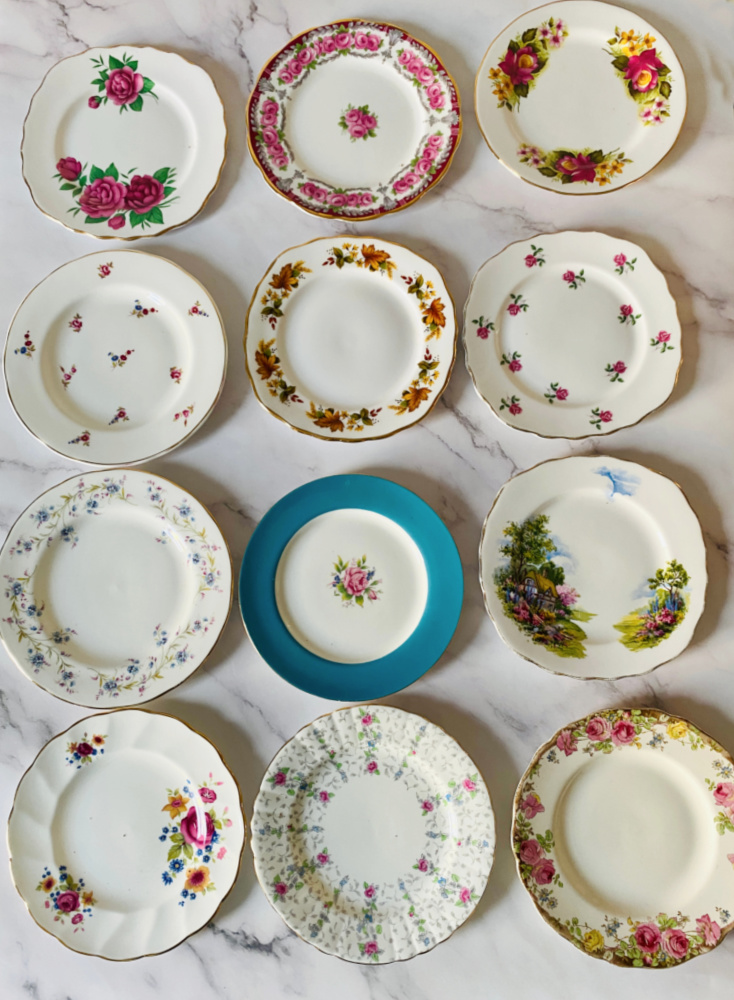 12 vintage side plates with various colours and patterns