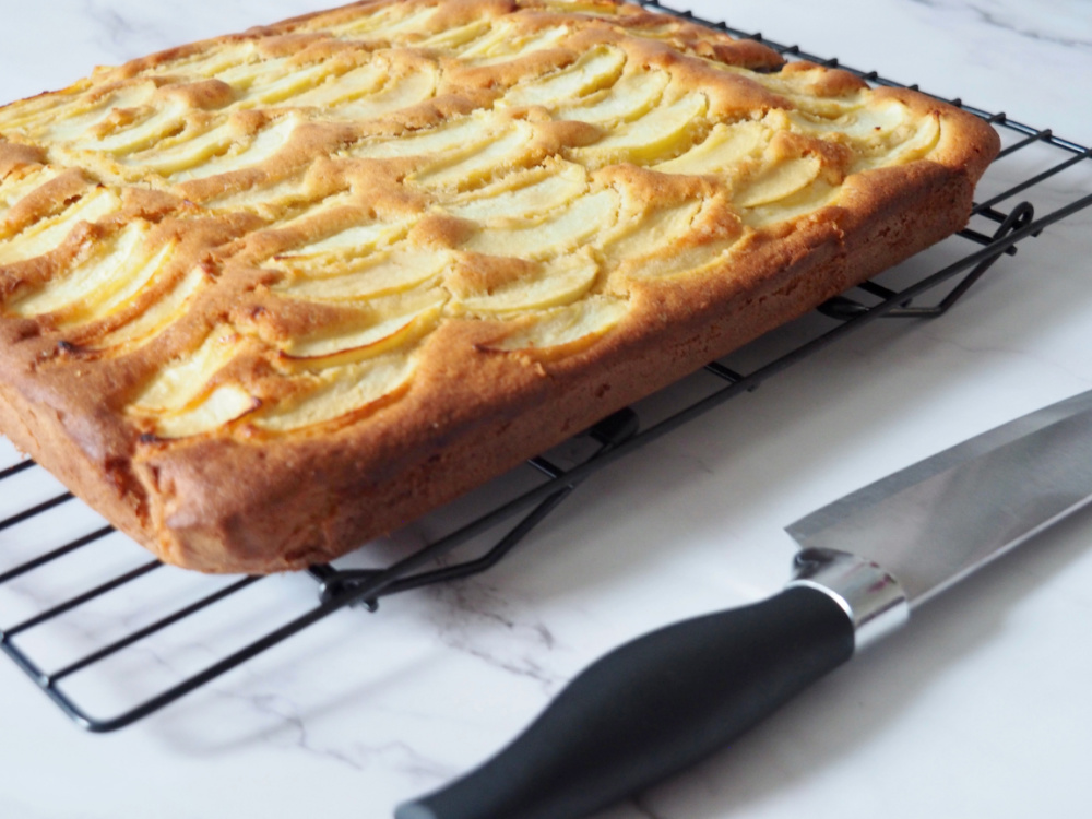 apple traybake on cooling rack with large knife