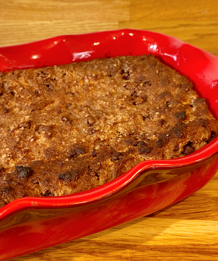 side view of choc chip bread pudding in wavy red dish