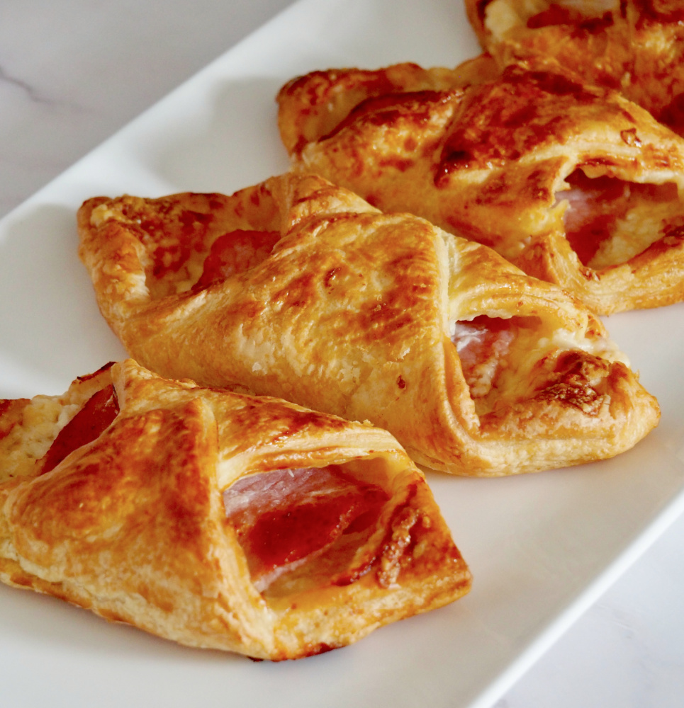 cheesy turnovers with bacon on a long rectangular plate