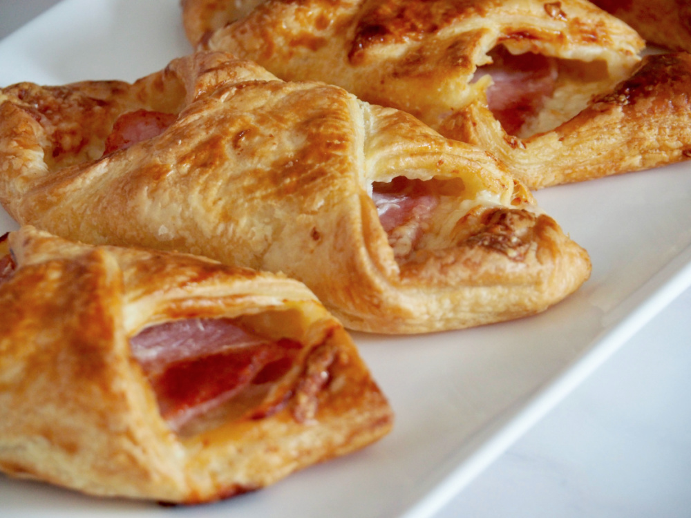 close up of cheesy turnovers on long rectangular plate