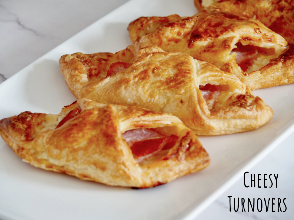 side view of a dish of cheesy turnovers