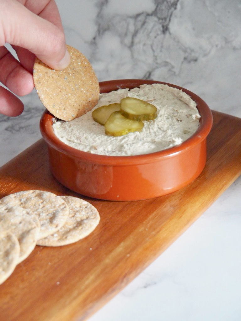 cracker dipping into a bowl of smoked mackerel dip