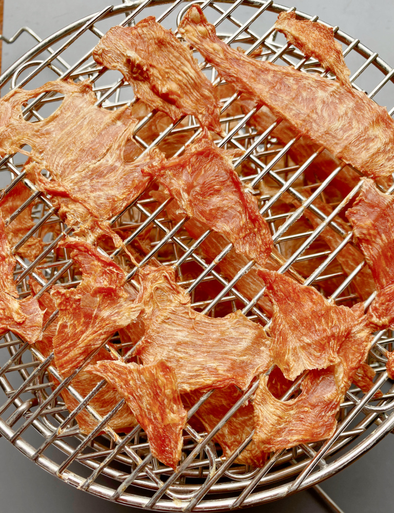 dehydrated chicken jerky on dehydrating rack