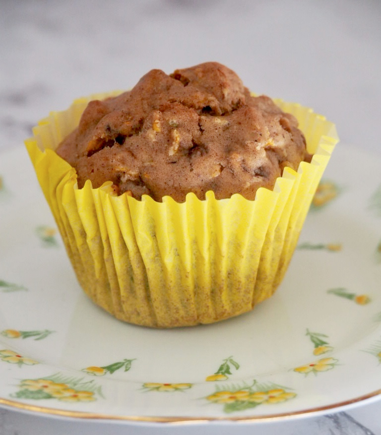 a courgette cupcake in yellow paper case on small yellow plate decorated with yellow flowers