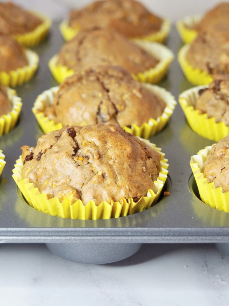 close up of muffin tin with freshly baked courgette cupcakes