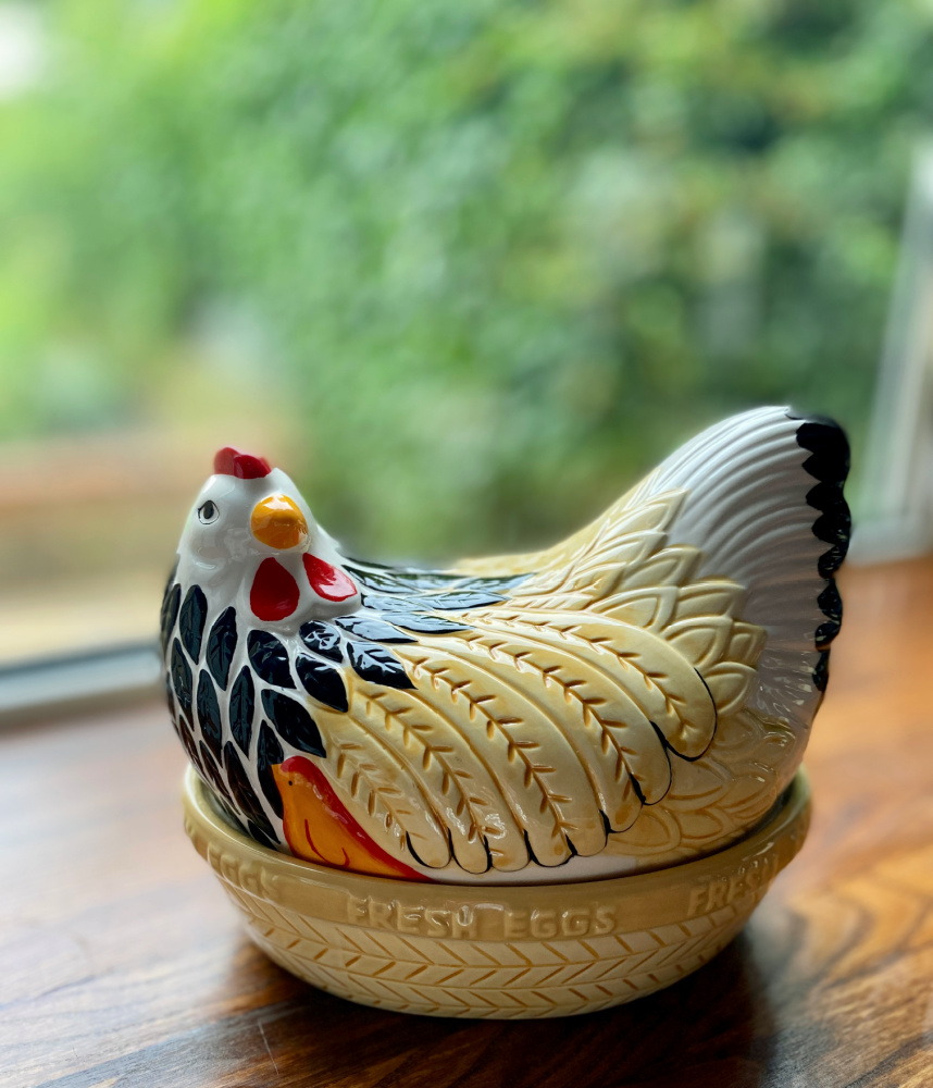 hen shaped ceramic egg basket with painted red crown and black chest feathers