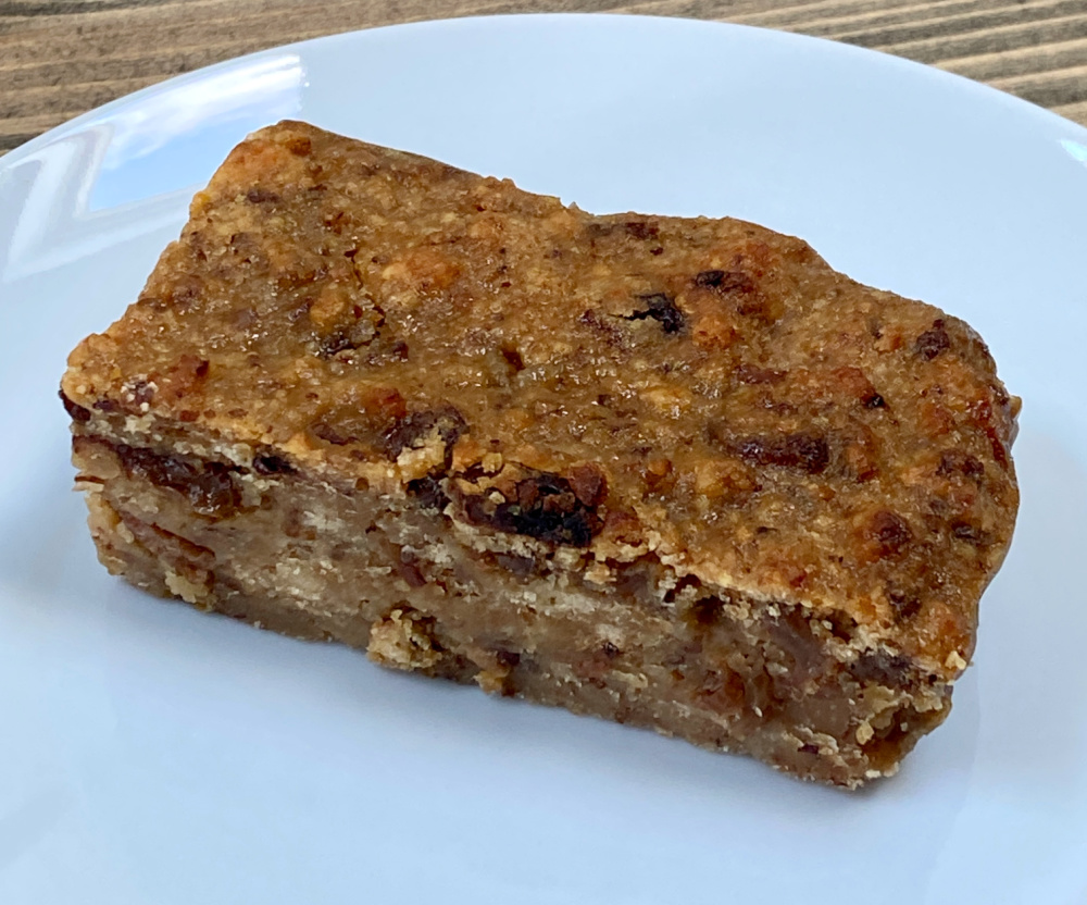 a slice of scone pudding on a white plate