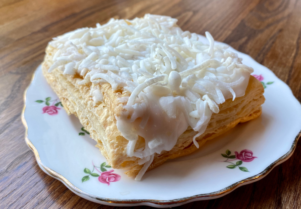 London cheesecake on a small side plate decorated with pink roses